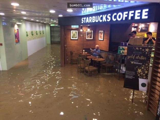 強者爺爺在颱風淹水時仍「淡定坐在星巴克喝咖啡看報紙」，這超有意境的畫面已經成為網友最愛的PS修圖素材了！